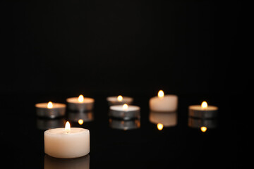 Burning candles on dark background