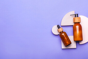 Bottles of cosmetics for hair on color background