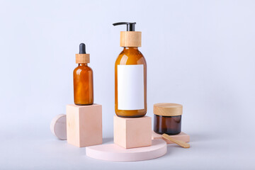 Bottles of cosmetics for hair on white background