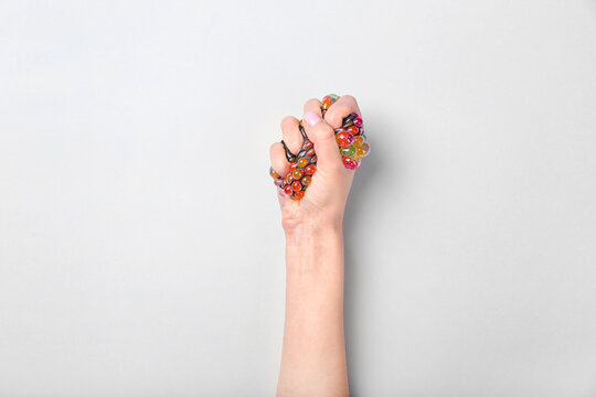 Female Hand Squeezing Stress Ball On White Background