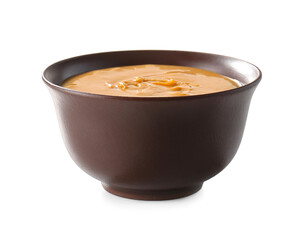 Bowl with tasty peanut butter on white background