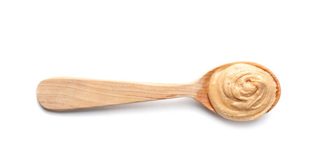 Spoon with tasty peanut butter on white background