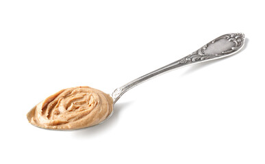 Spoon with tasty peanut butter on white background