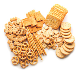 Tasty different crackers on white background