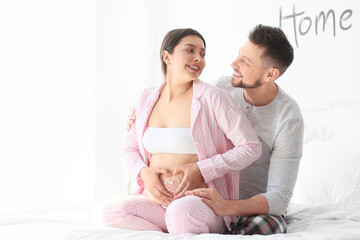 Beautiful pregnant couple at home