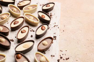 Tasty chocolate candies on color background, closeup