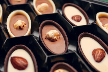 Box with tasty chocolate candies, closeup