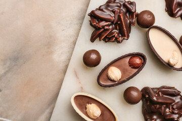Different chocolate candies on grunge background, closeup