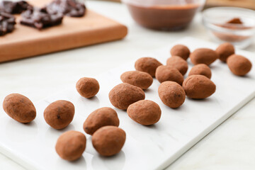Tasty chocolate candies on light background, closeup