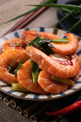 Delicious pan-fried shrimp on dark wooden table background.