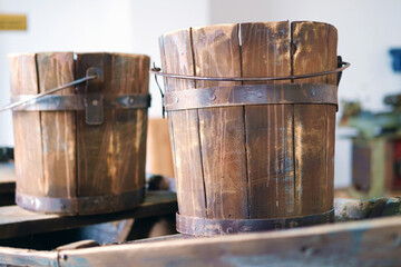 Obraz premium Old wooden buckets on wooden surface, selective focus
