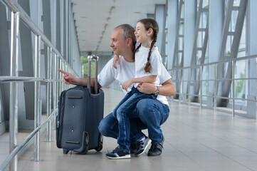 Fototapeta na wymiar Happy father and daughter are ready to board or meet someone at the airport.