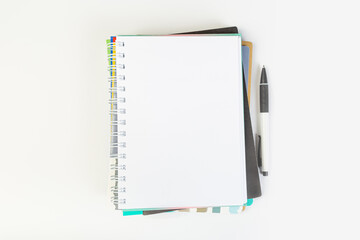 top view of an open notebook with a pen on a gray background, school notebooks with a spiral spring, office notepad. desktop concept, learning