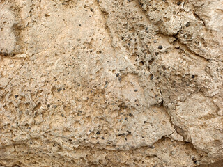 textured sand-colored stone wall background