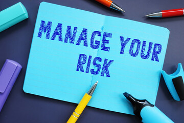 Business concept about Manage Your Risk with sign on the piece of paper.