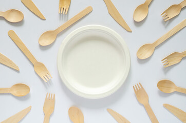White disposable, compostable dish with fork and spoon on white background for world environment day concept.