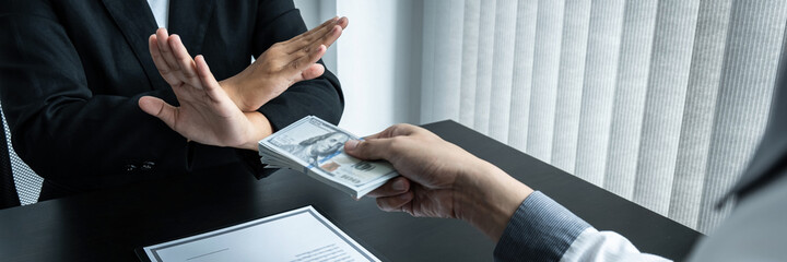 Business woman refusing and don't receive money banknote in envelope offer from business people to...