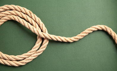 Brown rope on green background.