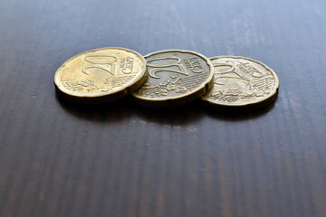 20 Euro cent coins on wood table. 