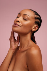 Woman touching her smooth and healthy facial skin - obrazy, fototapety, plakaty