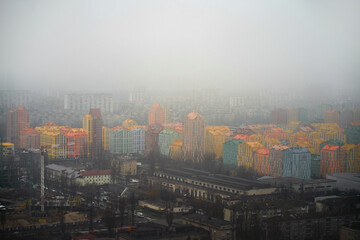 Aerial view of infrastucture in the colorful modern city. Comfort town Kyiv Ukraine. Foggy dull day in the capital city