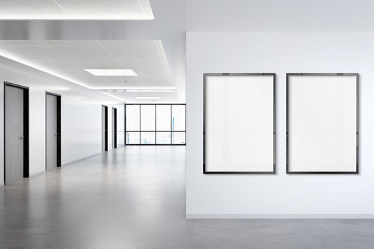 Two vertical frames Mockup hanging on wall. Mock up of billboards in modern concrete office interior 3D rendering