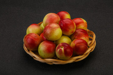 Sweet small nectarines in the basket
