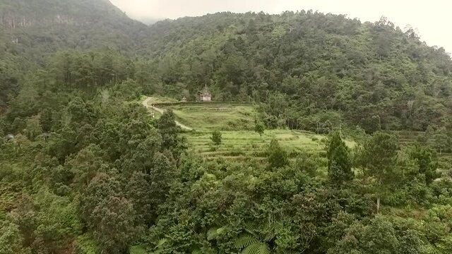 Hindu temple aerial footage in Bandungan National Park, Central Java, Indonesia. Shot from drone flying forward