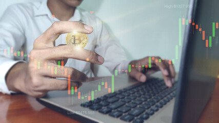 Bitcoin gold coin and defocused chart background. Business man with bitcoins. Virtual cryptocurrency concept.