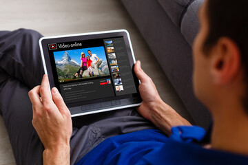 Man watching videos online on tablet