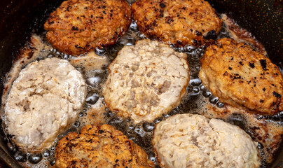 Minced meat cutlets are fried in oil