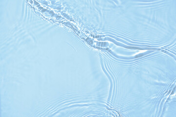 De-focused blurred transparent blue colored clear calm water surface texture with splashes and...