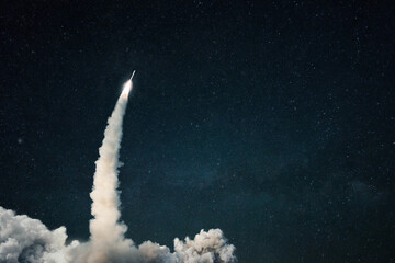 Rocket lift off into space. Spaceship launch with smoke on the starry sky. Space and travel...