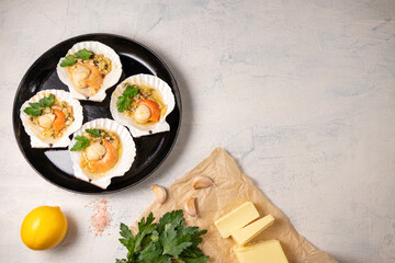 baked scallops with caviar and creamy garlic sauce. Scallops, lemon, garlic, parsley, butter and salt. Recipe for cooking scallops with caviar. Top view. Copy space