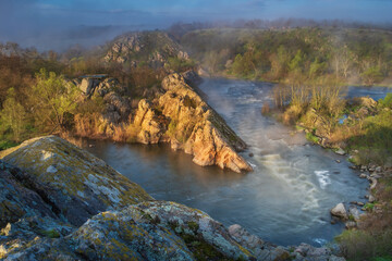 Naklejka na ściany i meble silent morning in river canyon with first sun rays and fog
