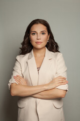 Smart successful businesswoman with crossed arms standing on white background