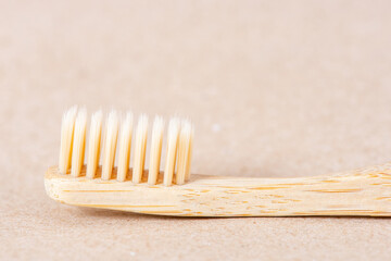 Eco friendly bamboo toothbrush close up on brown background. Zero waste concept