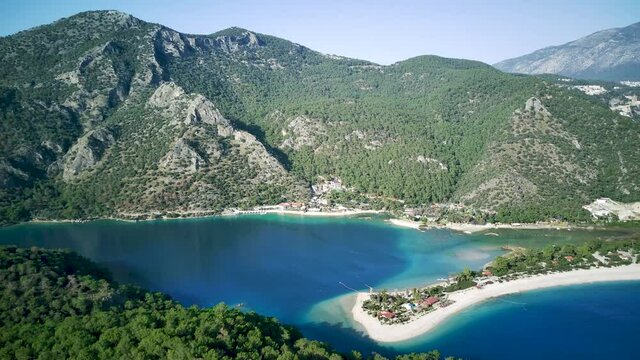 Amazing high angle top drone view on world famous paragliding and parasailing turkish spot for extrim parachute sport in Oludeniz in Fethiye, Turkey
