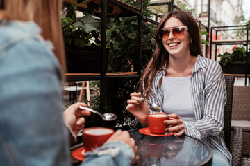 Two Young Women Drinking Coffee in Cafe Outdoors, Lunch Time Concept, Brunette Girl in Focus