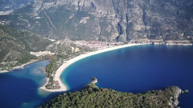 Amazing high angle top drone view on world famous paragliding and parasailing turkish spot for extrim parachute sport in Oludeniz in Fethiye, Turkey
