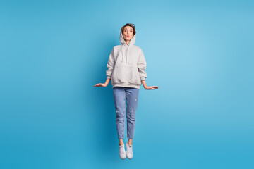 Full length body size view of pretty cheerful girl jumping having fun pout lips isolated over bright blue color background