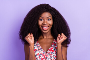 Photo of young attractive afro girl happy positive smile rejoice victory fists hands isolated over purple color background