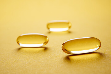 Omega 3 capsules.Vitamin drop pill capsule. Shining golden essence droplet. 