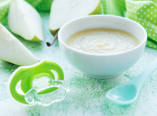 Bowl with fruit baby food and pears