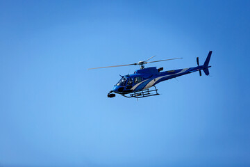 Fototapeta premium Helicopter on the right against a clear blue sky