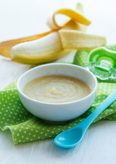 Bowl with fruit baby food and banana