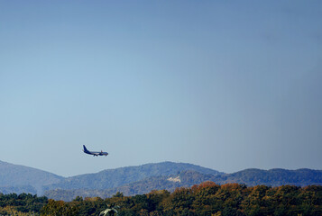 Plane land on the background of the sky and mountains