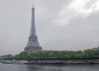 View of the Port de Suffren and the Eiffel Tower. In the port there are ships and cars