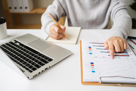 businesswoman working about analysis financial statements, business document, chart and graph paper, accounting concept.