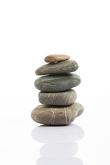 Stones standing in balance on grey background